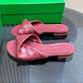 BOTTEGA VENETA BLINK FLAT MULE IN BERRY RED INTRECCIATO LEATHER